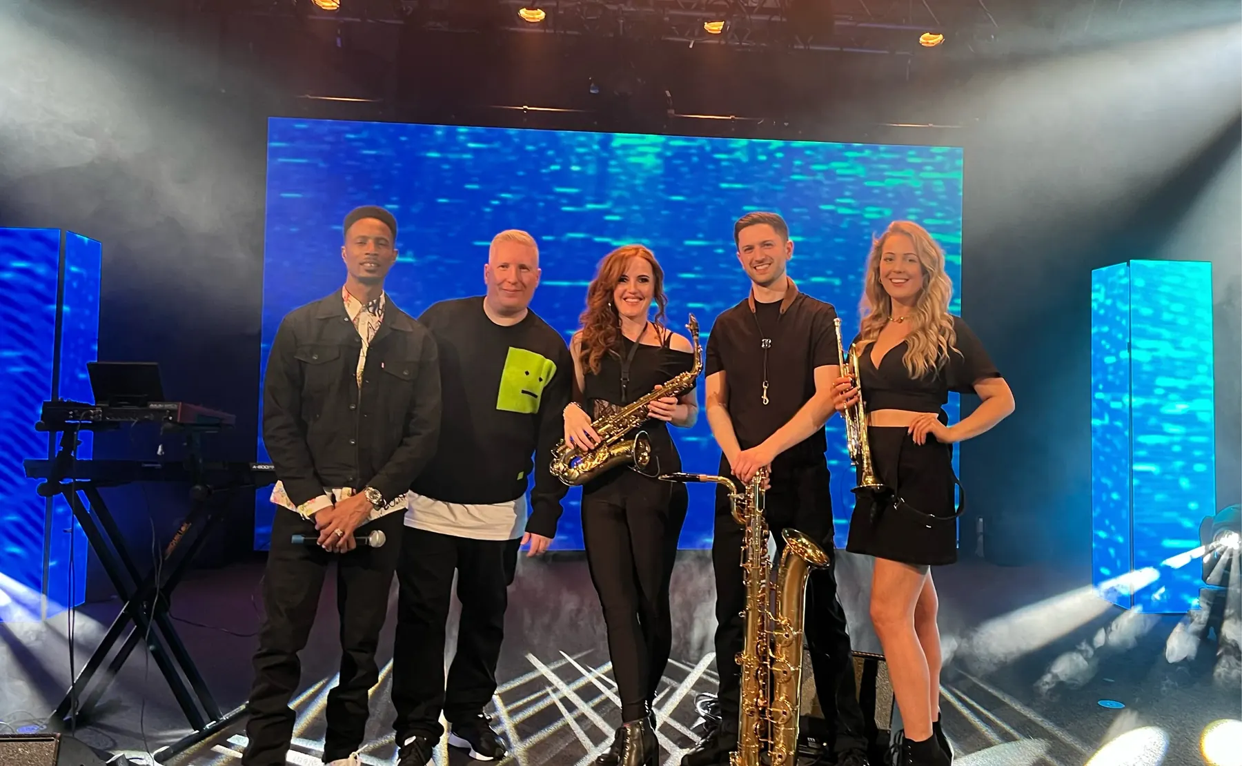 Sarah Saxophone performing with live musicians at a BBC event
