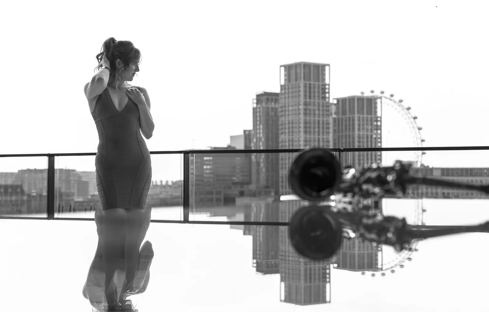 Sarah Saxophone in a red dress against the London skyline